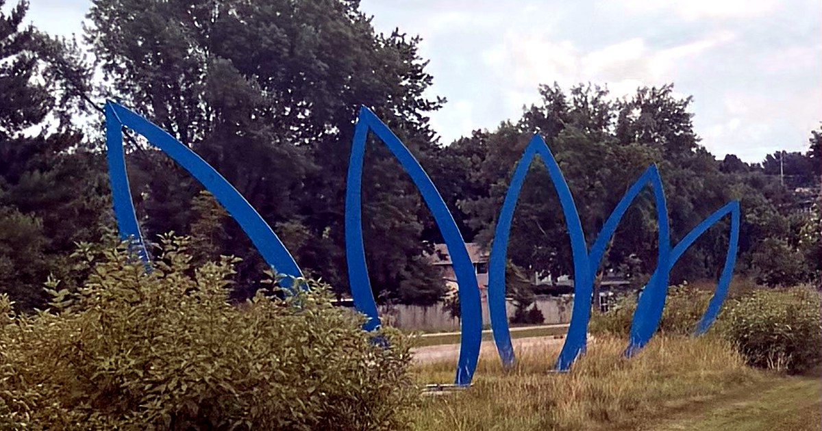 Blue sculptural installation in a landscaped Iowa park